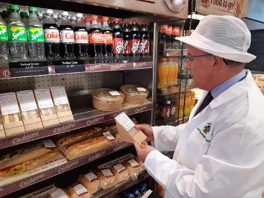 Environmental Health Officer David Jarvis checks allergen information and signage at MI Dicksons