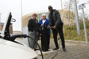 Caption: Leader, Councillor Tracey Dixon is pictured with Councillor Margaret Meling and Connected Kerb’s Brand Ambassador Martin Offiah MBE at one of the new charging points at The Word car park, South Shields.